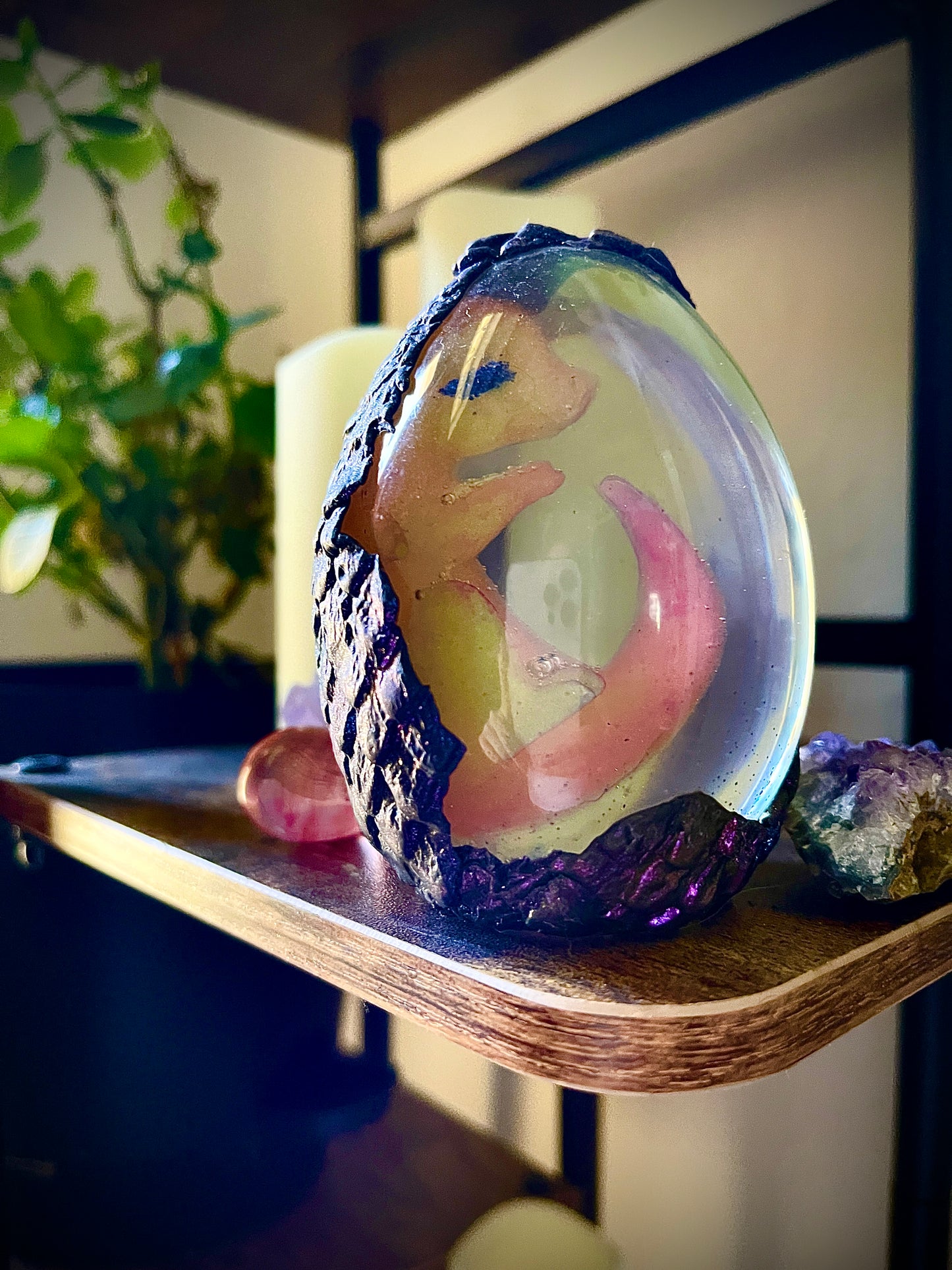 Decorative glass sphere with a figurine on a wooden shelf